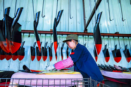 LUANNAN COUNTY, Hebei Province, China-April 15, 2019: Workers are busy on the production line in a steel shovel production plant.のeditorial素材
