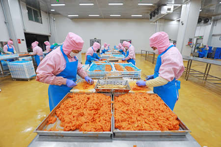 LUANNAN COUNTY, Hebei Province, China-July 28, 2020: Workers are busy in the chicken segmentation...