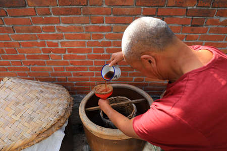 LUANNAN COUNTY, Hebei Province, China-September 4, 2020: Farmers are checking the degree of shrimp oil fermentation in the processing plantのeditorial素材