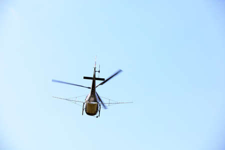 Agricultural helicopters for controlling Hyphantria cunea spray pesticides over the cityの写真素材
