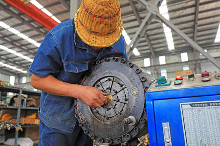 LUANNAN COUNTY, Hebei Province, China-July 11, 2020: Workers are assembling mechanical parts on the production lineのeditorial素材