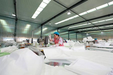 LUANNAN COUNTY, Hebei Province, China-September 27, 2020: workers are busy on the fiber bag sewing lineのeditorial素材
