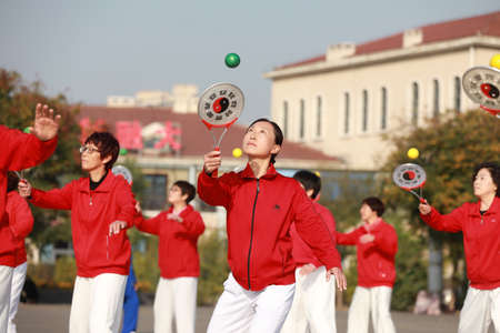 LUANNAN COUNTY, Hebei Province, China-October 18, 2020: Ladies are practicing Tai Chi softball in the squareのeditorial素材