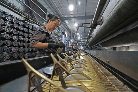 LUANNAN COUNTY, Hebei Province, China-August 28, 2020: The workers are working on a mechanical fishing net in a net factoryのeditorial素材