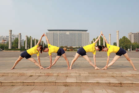 LUANNAN COUNTY, Hebei Province, China-September 26, 2020: Women practice yoga on the lawn in the parkのeditorial素材