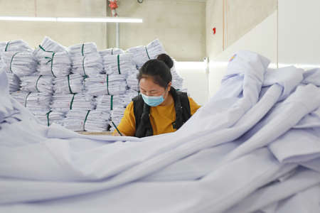 LUANNAN COUNTY, Hebei Province, China-April 8, 2020: The workers are busy on the production line in a garment factory.のeditorial素材