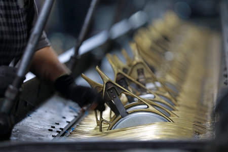 The workers are working on a mechanical fishing net in a net factory