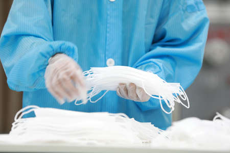 Workers are busy on the production line in a Medical mask factory.の写真素材