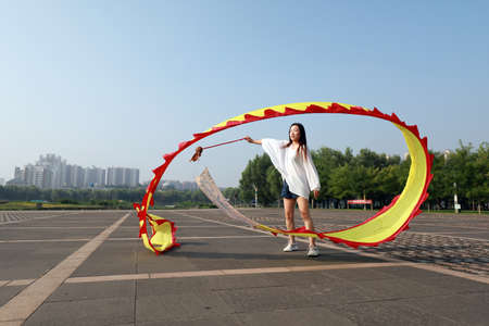 LUANNAN COUNTY, Hebei Province, China-August 1, 2020: People are shaking ribbon fitness in the squareのeditorial素材
