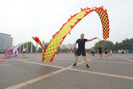 LUANNAN COUNTY, Hebei Province, China-August 2, 2020: People are shaking ribbon fitness in the squareのeditorial素材