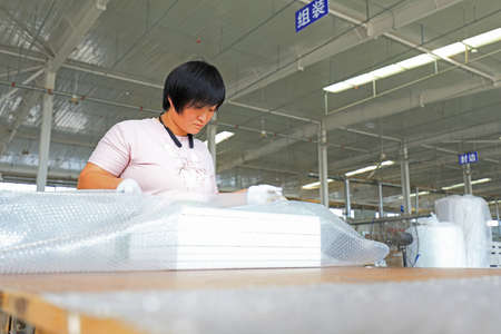 LUANNAN COUNTY, Hebei Province, China-September 4, 2020: The workers are busy on the production line in the furniture factoryのeditorial素材