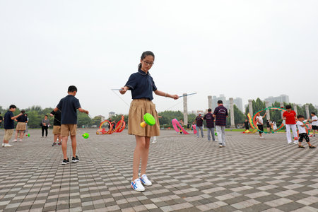 LUANNAN COUNTY, Hebei Province, China-August 2, 2020: A little girl is practicing playing diabolo in the parkのeditorial素材