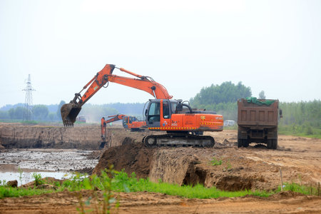 LUANNAN COUNTY, Hebei Province, China-July 11, 2020: Excavator operation in flood control engineering construction siteのeditorial素材