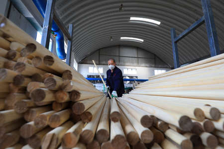 LUANNAN COUNTY, Hebei Province, China-May 29, 2020: Workers are busy in a factory on the wooden handle production lineのeditorial素材