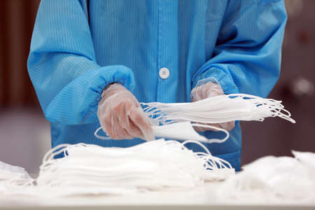 Workers are busy on the production line in a Medical mask factory.の写真素材