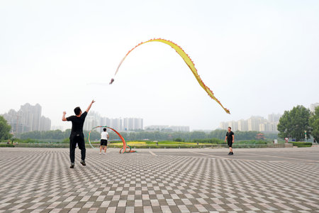 LUANNAN COUNTY, Hebei Province, China-August 4, 2020: People shake colored silk to keep fit in the parkのeditorial素材