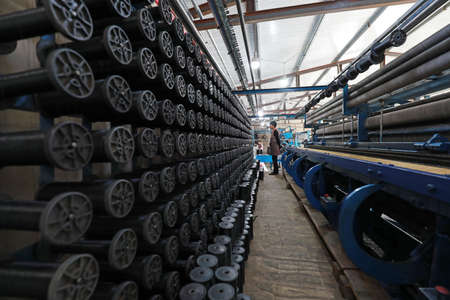LUANNAN COUNTY, Hebei Province, China-August 20, 2020: Workers operate mechanical textile fishing nets in a net farmのeditorial素材