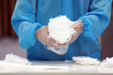Workers are busy on the production line in a Medical mask factory.の写真素材