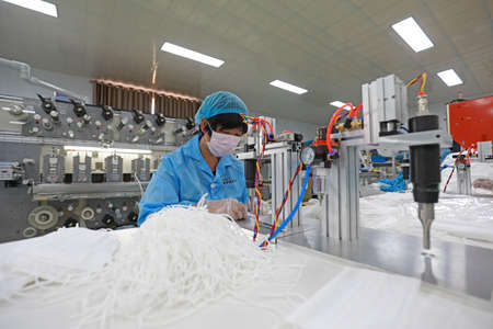 LUANNAN COUNTY, Hebei Province, China-April 15, 2020: Workers are busy on the production line in a...