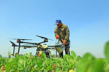 LUANNAN COUNTY, Hebei Province, China-April 27, 2020: A skilled worker is debugging the agricultural...