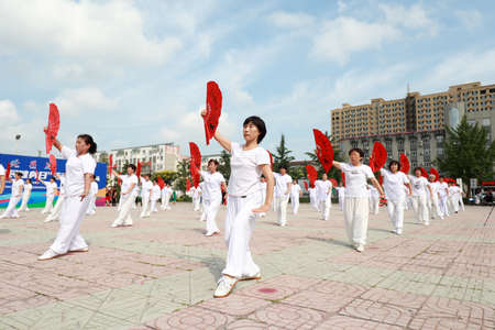 LUANNAN COUNTY, Hebei Province, China-August 8, 2020: People are practicing Tai Chi fans in the squareのeditorial素材