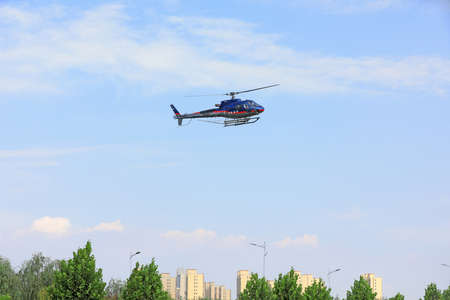 LUANNAN COUNTY, Hebei Province, China-September 7, 2020: Agricultural helicopters for controlling Hyphantria cunea spray pesticides over the cityのeditorial素材