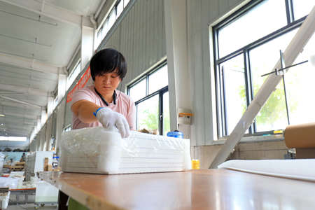 LUANNAN COUNTY, Hebei Province, China-September 4, 2020: The workers are busy on the production line in the furniture factoryのeditorial素材