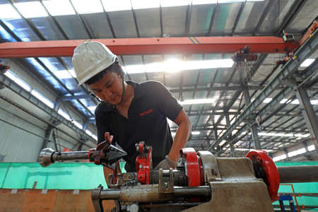 LUANNAN COUNTY, Hebei Province, China-July 10, 2020: workers work in a factory on a production lineのeditorial素材