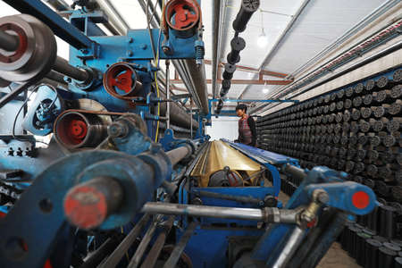 LUANNAN COUNTY, Hebei Province, China-August 20, 2020: Workers operate mechanical textile fishing nets in a net farmのeditorial素材
