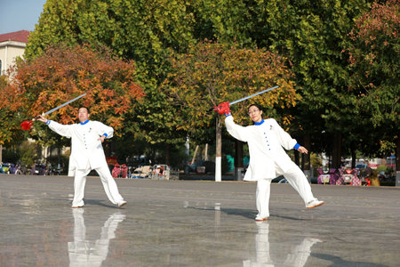 LUANNAN COUNTY, Hebei Province, China-October 18, 2020: People practice Taiji sword in the parkのeditorial素材