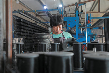 LUANNAN COUNTY, Hebei Province, China-August 20, 2020: Workers operate mechanical textile fishing nets in a net farmのeditorial素材