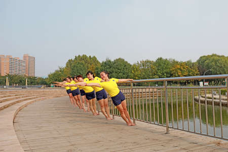 LUANNAN COUNTY, Hebei Province, China-September 26, 2020: Women practice yoga on the lawn in the parkのeditorial素材