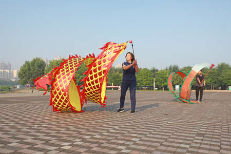 LUANNAN COUNTY, Hebei Province, China-August 1, 2020: People are shaking ribbon fitness in the squareのeditorial素材