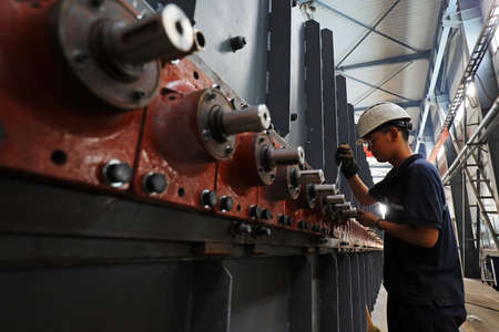 LUANNAN COUNTY, Hebei Province, China-July 10, 2020: workers work in a factory on a production lineのeditorial素材