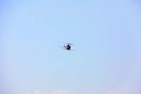 Agricultural helicopters for controlling Hyphantria cunea spray pesticides over the cityのeditorial素材