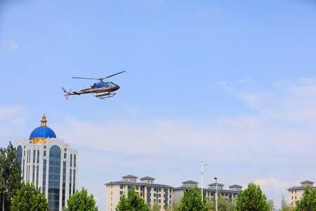 LUANNAN COUNTY, Hebei Province, China-September 7, 2020: Agricultural helicopters for controlling Hyphantria cunea spray pesticides over the cityのeditorial素材