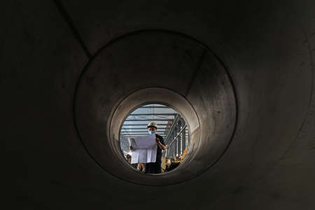 LUANNAN COUNTY, Hebei Province, China-July 11, 2020: Workers are checking drawings against machined parts at a job siteのeditorial素材