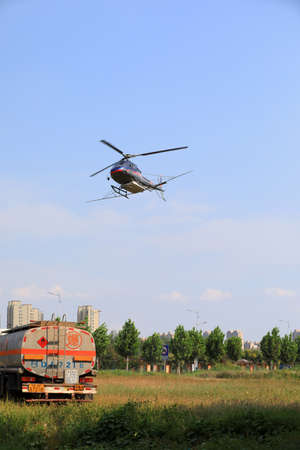 LUANNAN COUNTY, Hebei Province, China-September 7, 2020: Take off of agricultural helicopter to control Hyphantria cuneaのeditorial素材