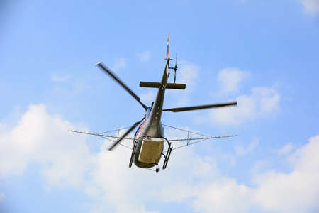 Agricultural helicopters for controlling Hyphantria cunea spray pesticides over the cityのeditorial素材