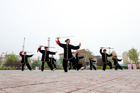 LUANNAN COUNTY, Hebei Province, China - April 29, 2019: people practice Tai Chi Sword in the park square.のeditorial素材