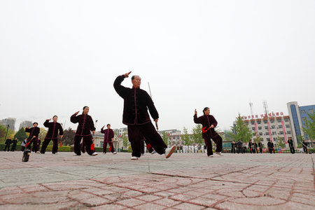 LUANNAN COUNTY, Hebei Province, China - April 29, 2019: people practice Tai Chi Sword in the park square.のeditorial素材
