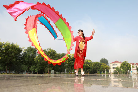Luannan County, China - July 30, 2019: People wave ribbons to exercise in parks, Luannan County, Hebei Province, China.のeditorial素材