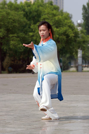 Tangshan City, Hebei Province, China - May 11, 2019: People are practicing Taijiquan in the park.のeditorial素材