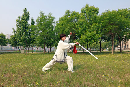 Tangshan City, Hebei Province, China - May 11, 2019: People are practicing Taiji sword in the park.