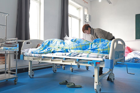 LUANNAN COUNTY, Hebei Province, China - November 22, 2019: A woman doing nursing training exercise.のeditorial素材