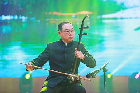 LUANNAN COUNTY, Hebei Province, China - December 30, 2019: Chinese traditional instrumental music performance erhu solo on stage.のeditorial素材