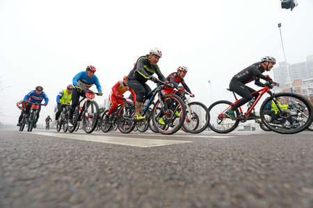 LUANNAN COUNTY, Hebei Province, China - November 23, 2019: Cyclists are trying to move forward, on a Road cycling competition site.のeditorial素材