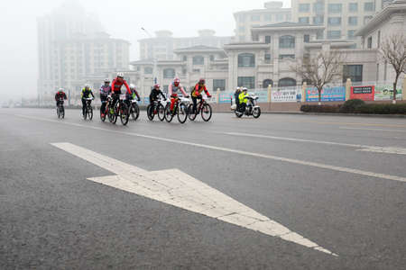 LUANNAN COUNTY, Hebei Province, China - November 23, 2019: Cyclists are trying to move forward, on a...