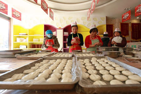 LUANNAN COUNTY, China - January 20, 2020: workers making traditional Chinese fried food, LUANNAN...
