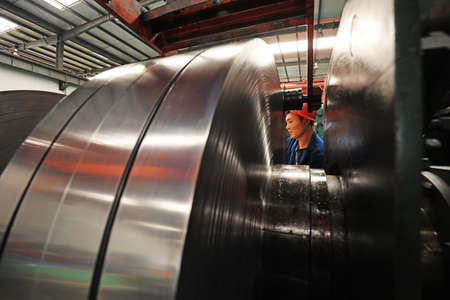 LUANNAN COUNTY, Hebei Province, China - March 25, 2020: Workers are busy on the strip production line in a factory.のeditorial素材